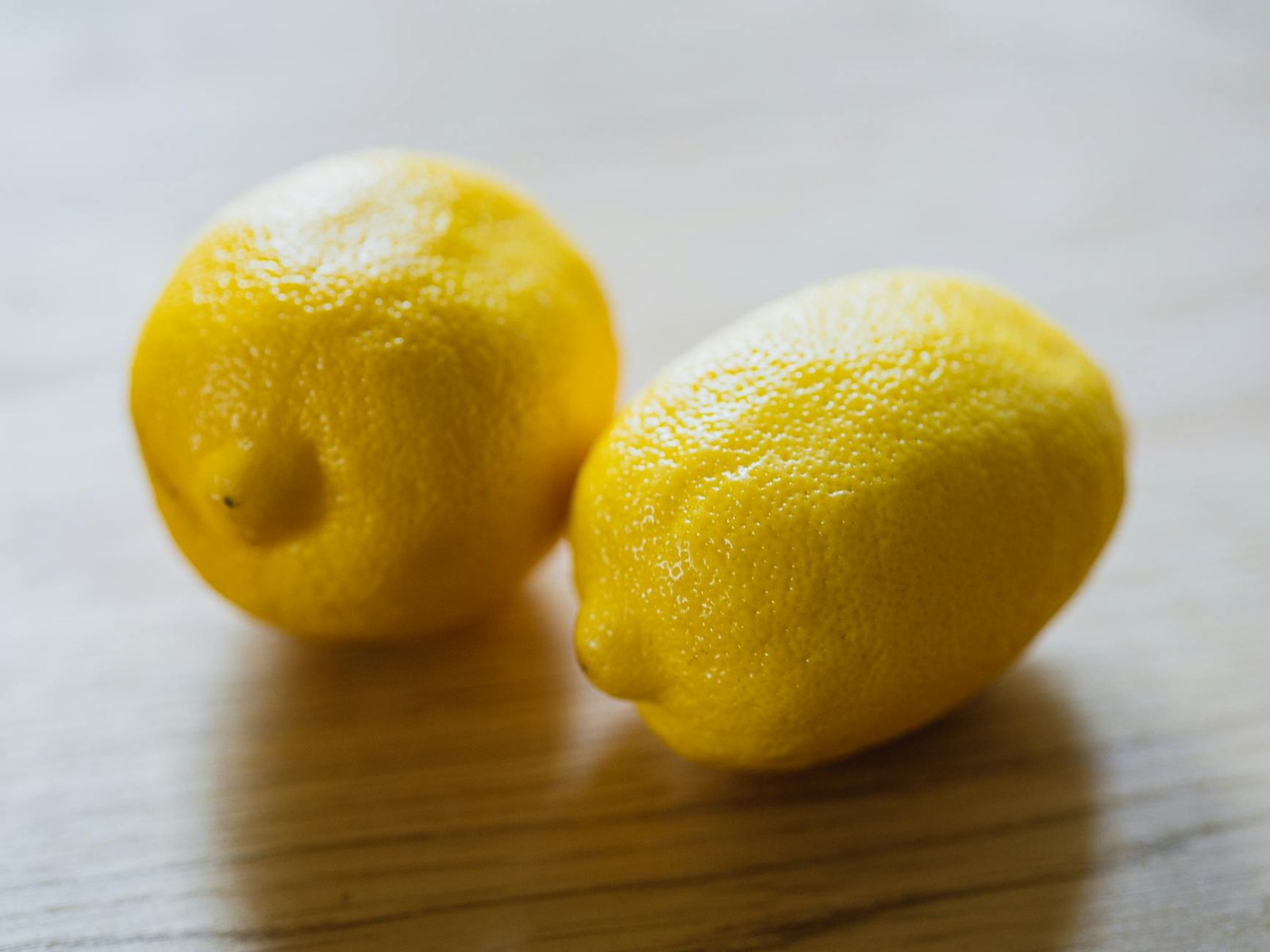 yellow lemons on wooden table