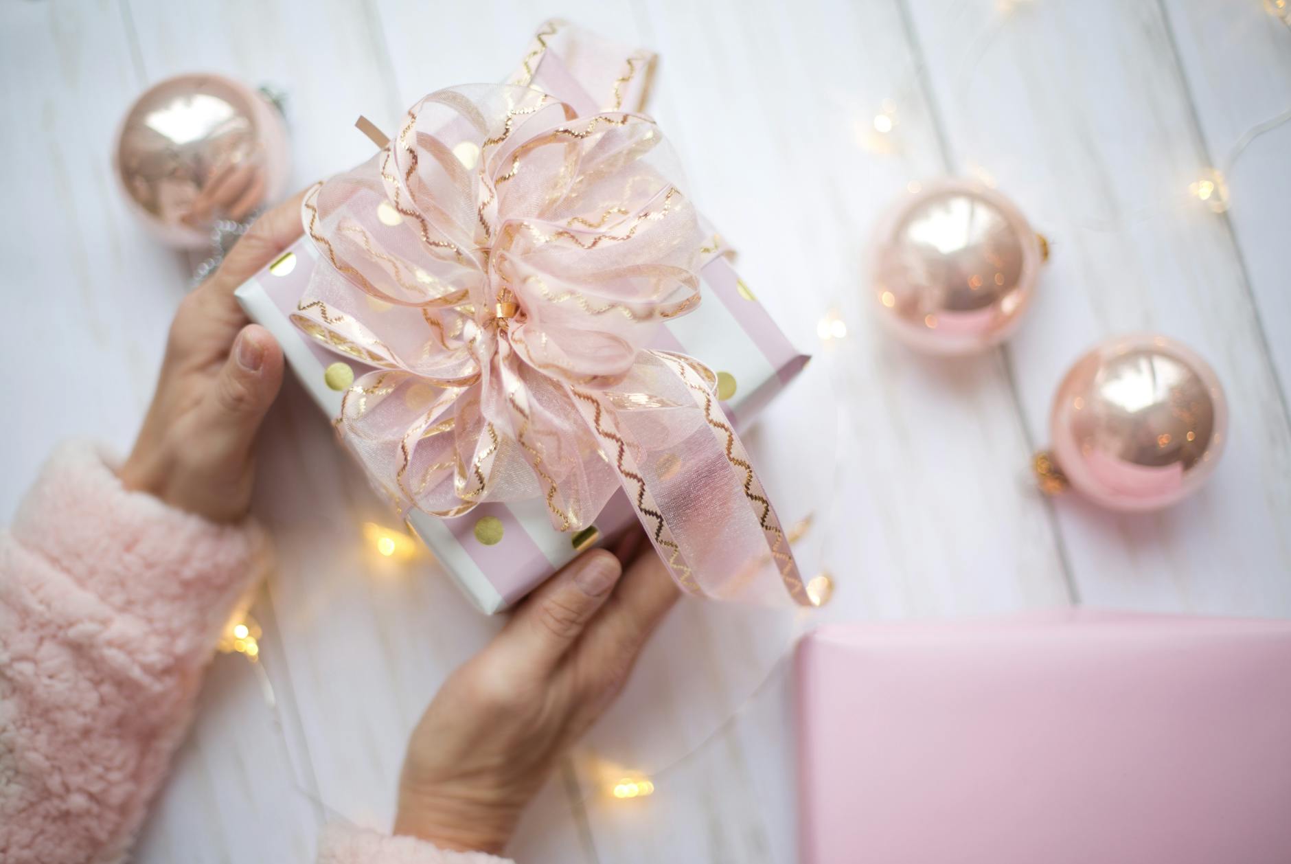 white and pink gift box with shiny pink ribbon