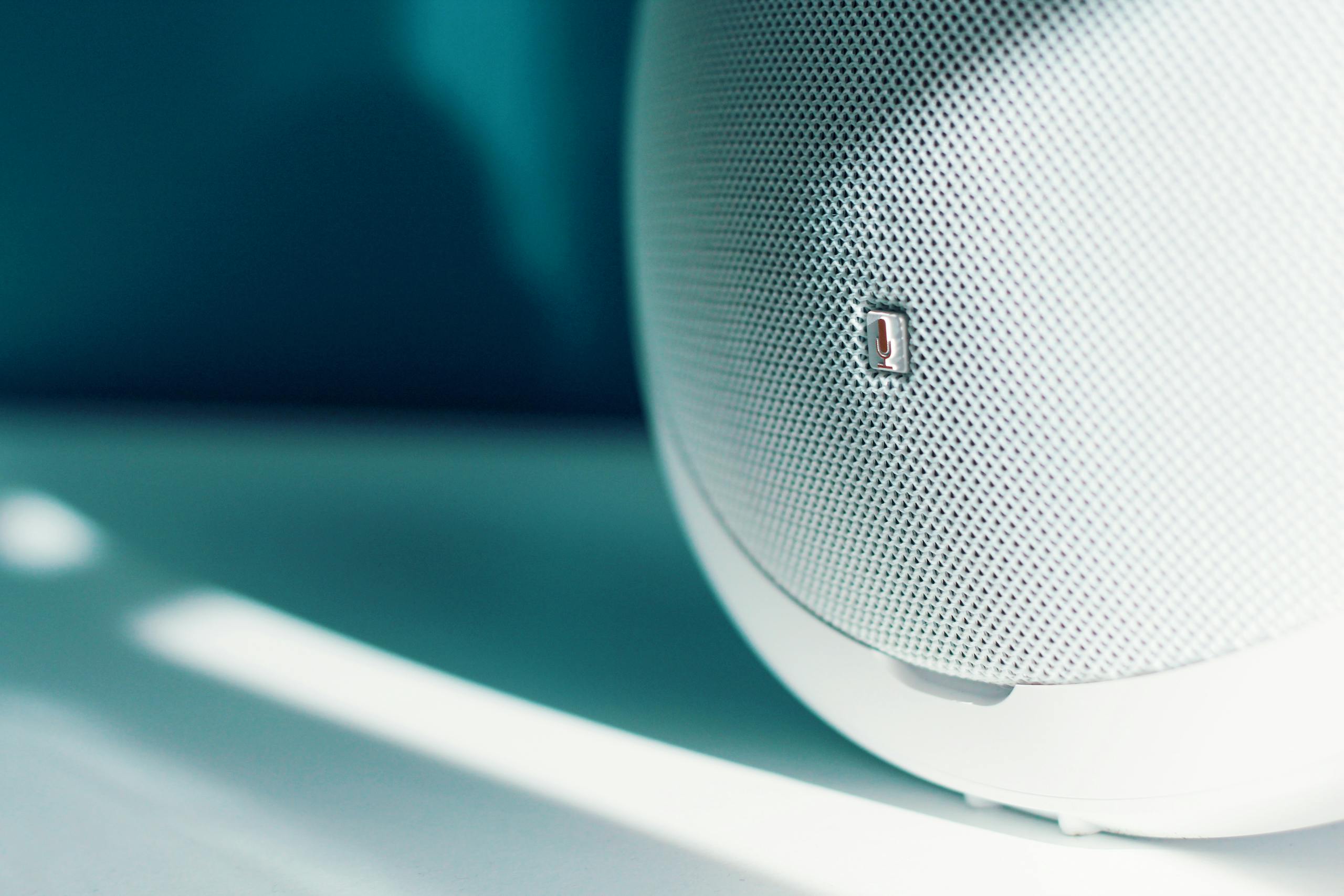 Close-up of a sleek and modern speaker with minimalistic design and subtle lighting.